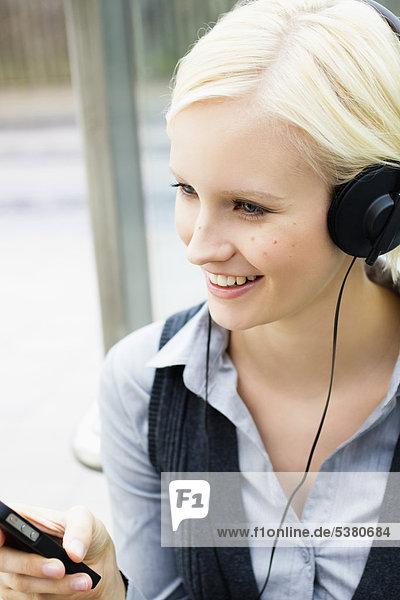 Young woman listening music  smiling
