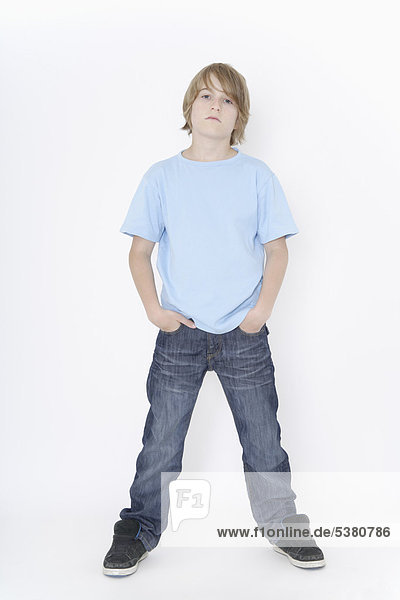 Boy standing against white background  portrait
