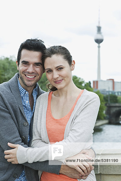 Germany  Berlin  Couple standing on bridge  portrait  smiling
