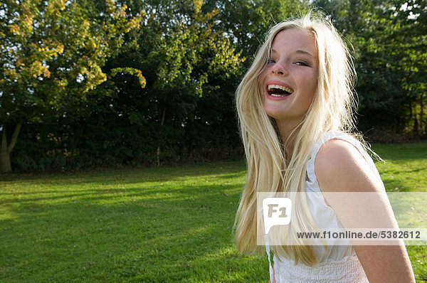 Teenage girl laughing outdoors