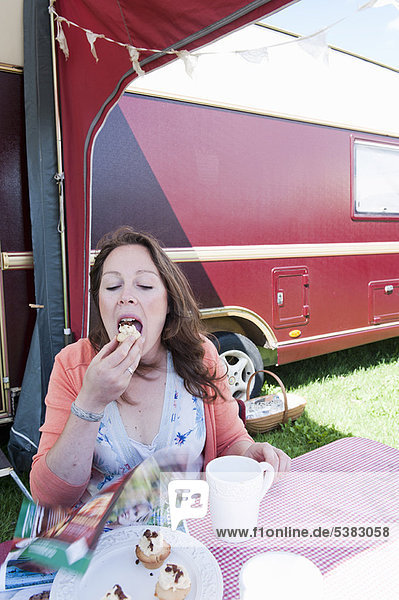 Woman picnicking outside trailer