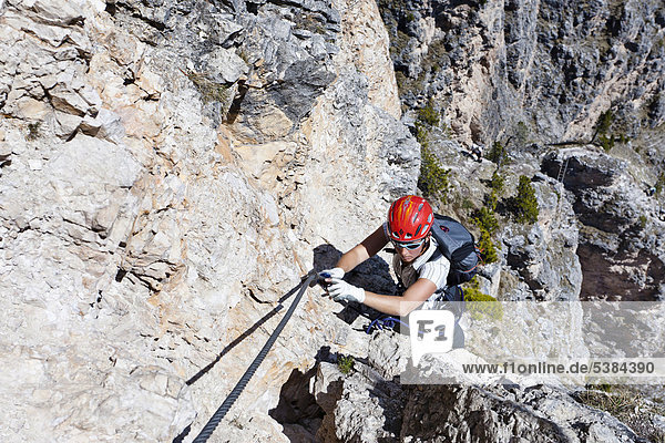 Climber climbing on the Stevia fixed rope route  Langental valley near Wolkenstein  Selva  province of Bolzano-Bozen  Italy  Europe
