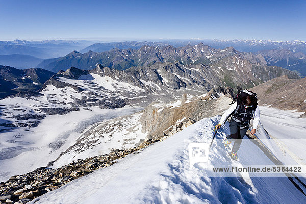 Mountaineer during the ascent to Mt Hochfeiler  Pfitschertal valley  Eisack valley and Wipptal valley at back  South Tyrol  Italy  Europe