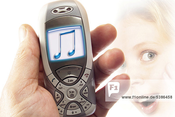 Hand holding a mobile phone with music-note display: Symbol for ringtones