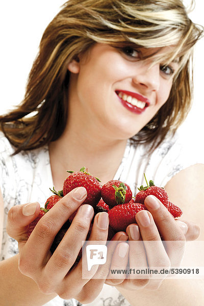 Young woman cupping strawberries in her hands