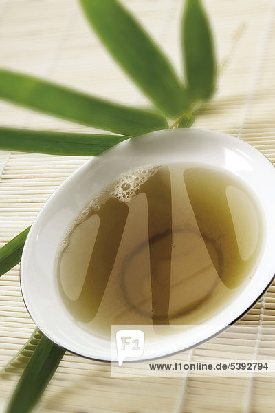 Schale mit Günem Tee und asiatischem Ambiente