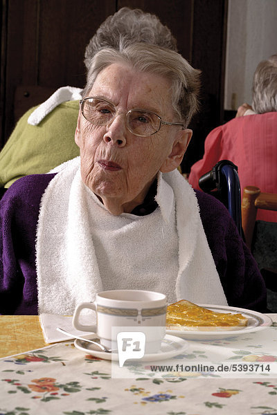 Senior citizen enjoying afternoon tea at an old-age home