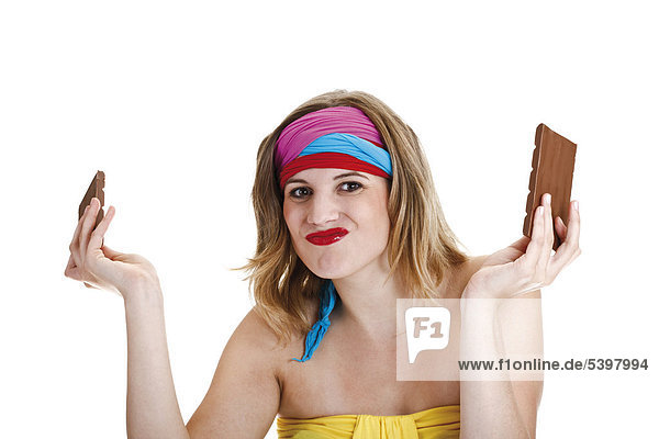 Young woman with colourful headbands and a chocolate bar in pieces