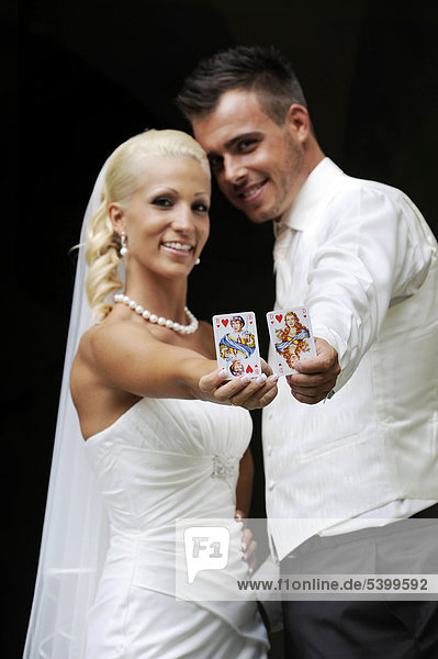 Wedding  bride and groom with playing cards  queen and jack of hearts