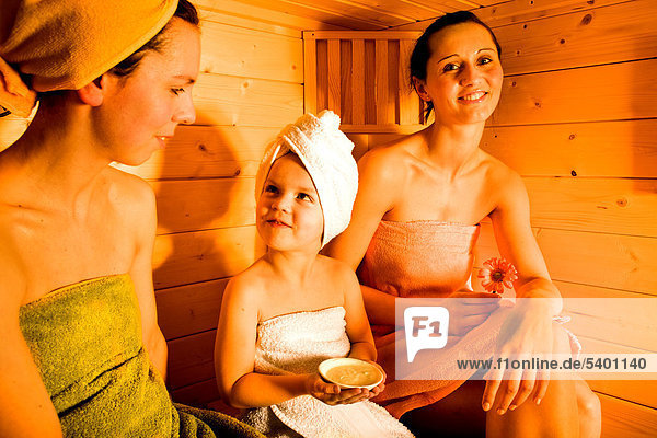 Young women and girl in the sauna