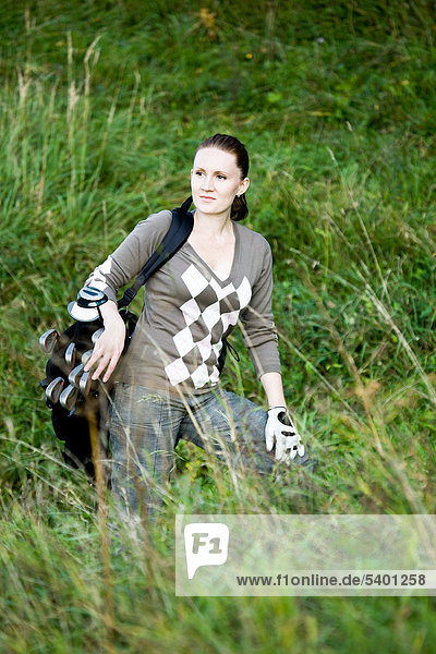 Woman with a golf bag  playing cross golf