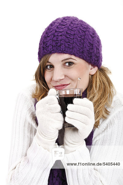 Young woman holding a glass of mulled wine
