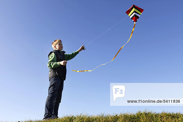Boy  12  flying a kite