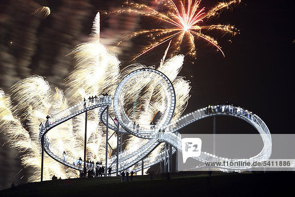'Fireworks display during opening of the walkable landmark sculpture in the shape of a roller coaster ''Tiger & Turtle ñ Magic Mountain'' by Heike Mutter and Ulrich Genth Angerpark on Heinrich-Hildebrand-Hoehe mining waste tip Duisburg North Rhine-Westphalia Germany Europe'