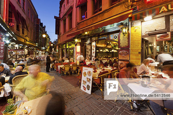 Guests sitting in street restaurants in the old town  Beenhouwersstraat  Brussels  Belgium  Europe