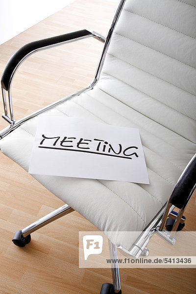 MEETING sign on an office chair