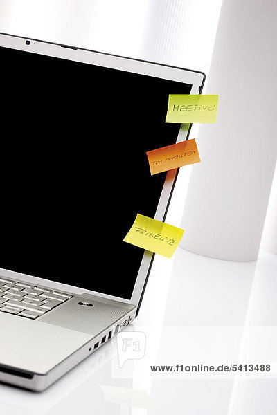 Colourful notepads on laptop