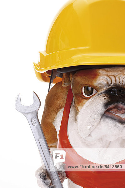 Bulldog figurine wearing a yellow construction helmet and holding a spanner