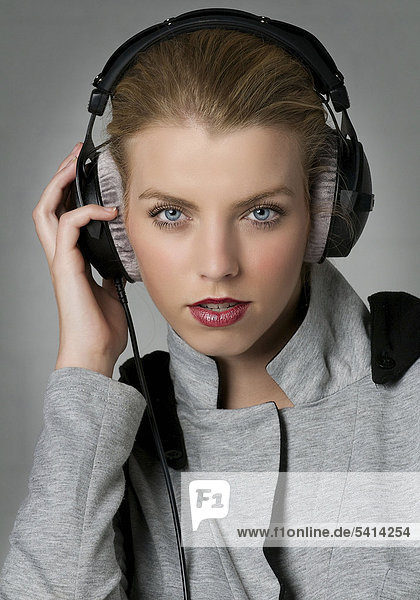 Young woman wearing professional headphones