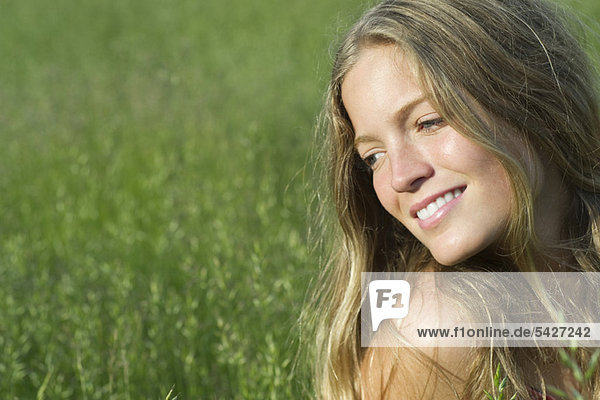 Young woman daydreaming outdoors  portrait
