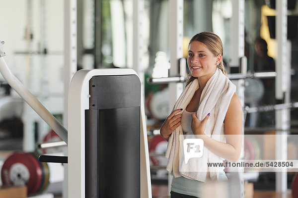 Young Woman Having a Break While Physical Training in a Gym