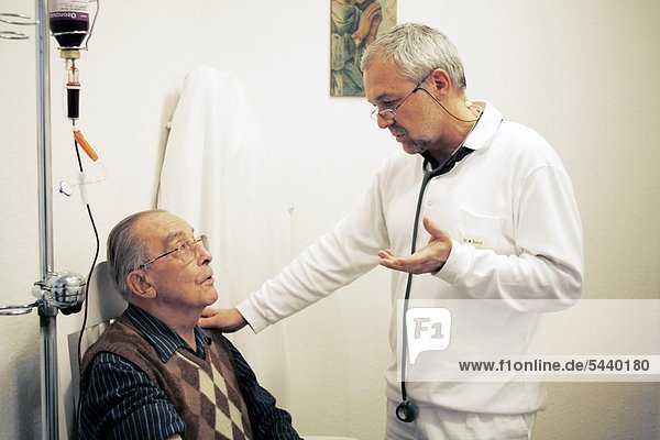 doctor explaining ozone therapy to elder patient