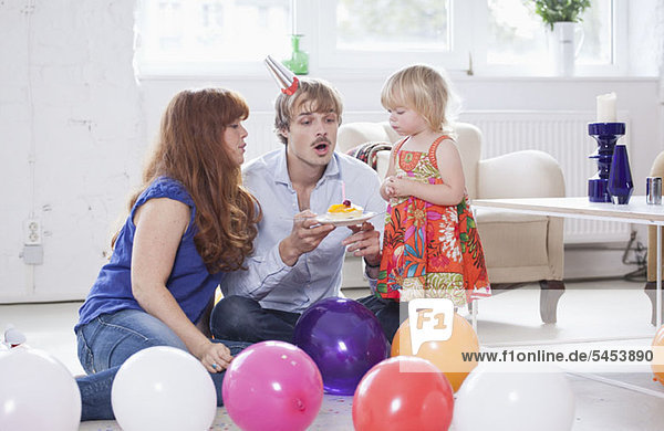 Young family celebrating a birthday