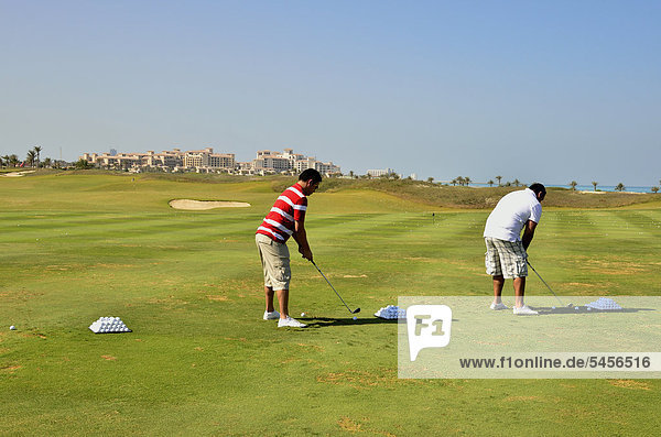 Golfers in the Saadiyat Beach Golf Club on Saadiyat Island  Abu Dhabi  United Arab Emirates  Arabian Peninsula  Asia