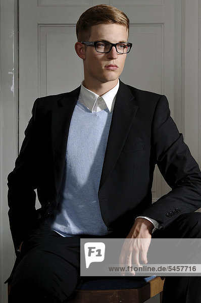 Junger Mann mit Brille und Anzug