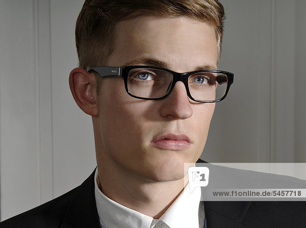 Young man wearing a suit and glasses  portrait