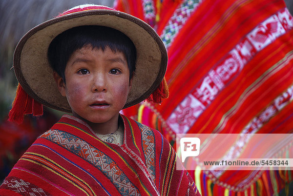 Little Indian boy wearing colourful festive costume  near Cusco or Cuzco  Peru  South America