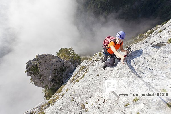 Young woman climbing in the Drachenwand Salzkammergut Austria