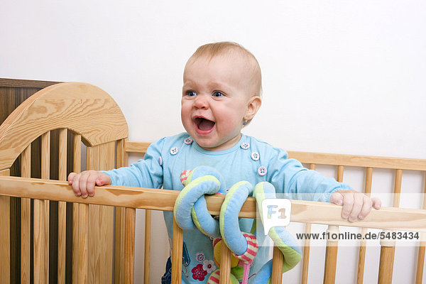 Baby  1 year  in a cot