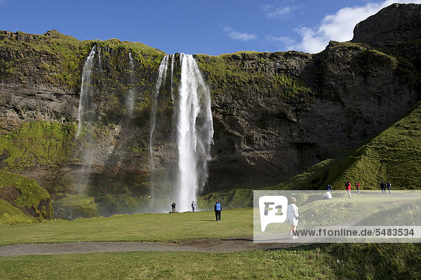 Tourists at the Seljalandsfoss waterfall  South Iceland  Iceland  Europe