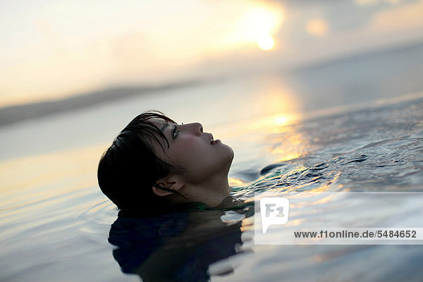 Young Asian woman relaxing in water