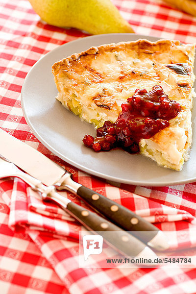 A quiche with pear and mushrooms  served on a plate