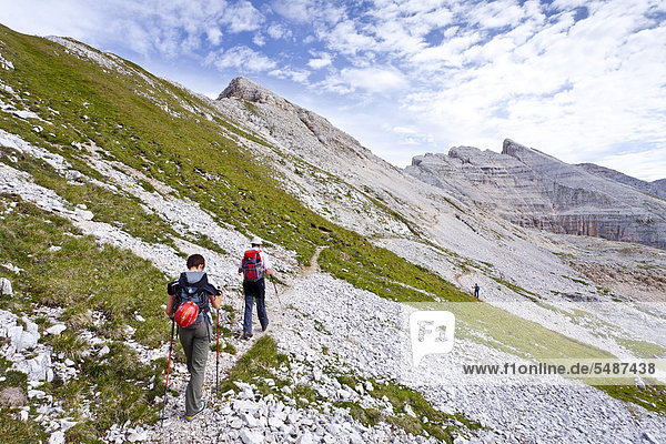 Climbers walking along the Latemar Crossing Climbing Route  with the Latemar Mountains at the rear  Alto Adige  Italy  Europe