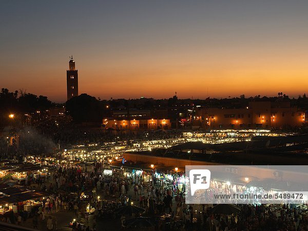 Morocco  Marrakesh  People at Djemaa el Fna square with Koutoubia Mosque at night