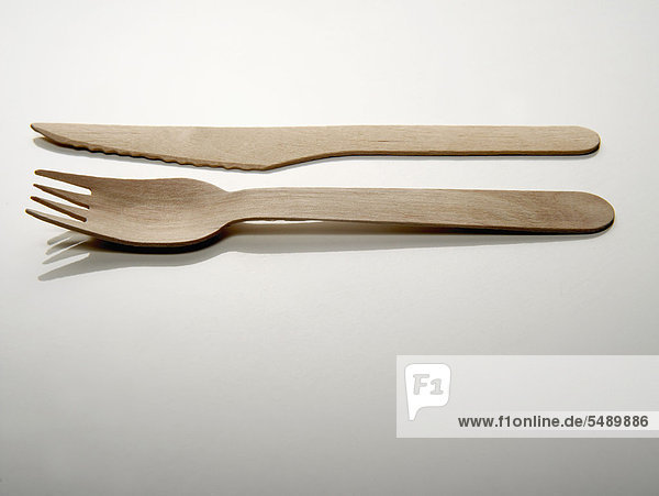 Wooden fork and knife on white background