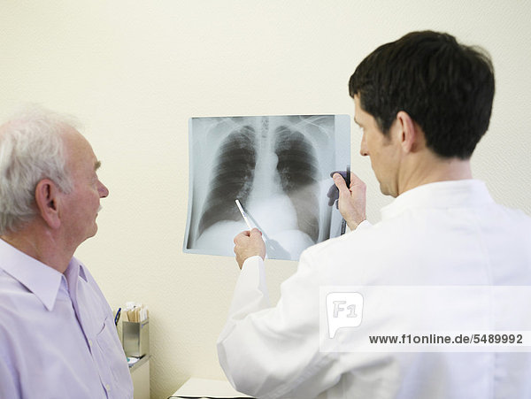 Germany  Hamburg  Doctor and patient with x-ray report in clinic