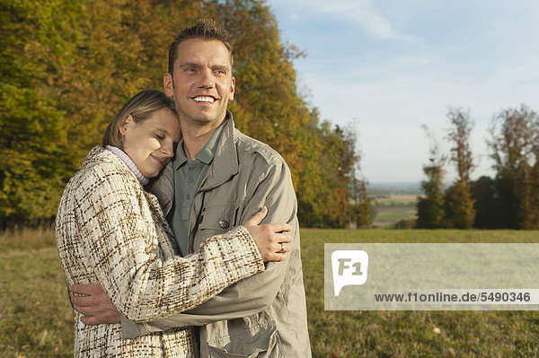 Mid adult man holding woman smiling