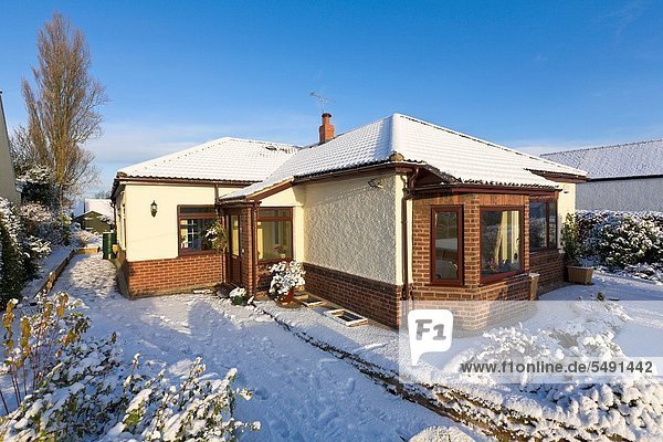 Bungalow in winter snow  Wirral  Merseyside  England