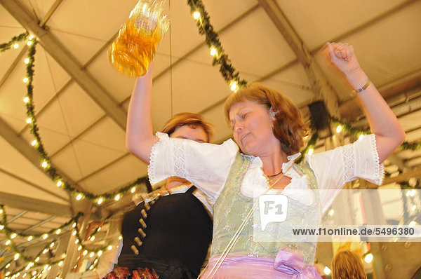 Frauen in Trachten tanzen auf dem Biertisch im Festzelt  Rosenheimer Herbstfest  Bayern  Deutschland  Europa