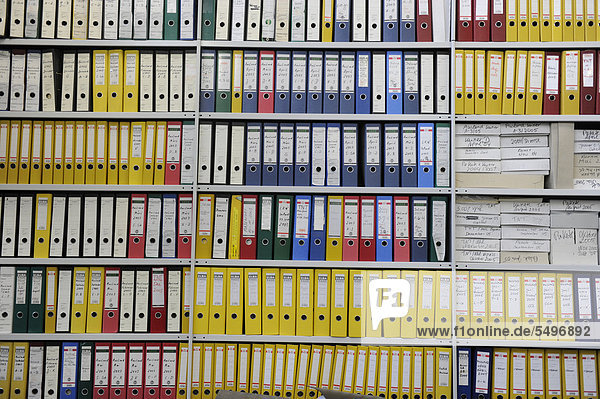Coloured file folders on a shelf