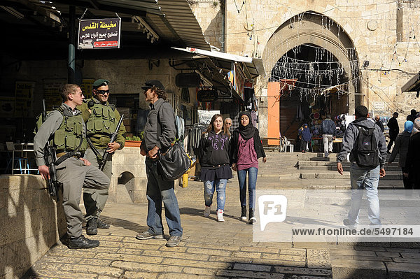 Israeli soldiers acting as security service at Damascus Gate  Palestinian youths passing  Arab quarter  old city  Jerusalem  Israel  Middle East