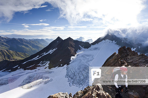 Mountaineer climbing from Muellerhuette mountain lodge to Wilder Pfaff mountain and Zuckerhuetl mountain lodge  Ridnauntal valley at the back  Passeier Valley above Timmelsjochstrasse road  province of Bolzano-Bozen  Italy  Europe