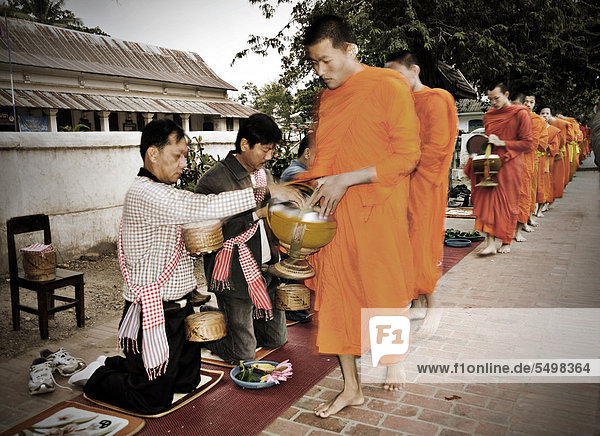 Buddhist monks begging for alms in Luang Prabang  Laos  Southeast Asia  Asia