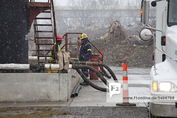 Arbeiter füllen Flüssigkeiten zum Hydraulic Fracturing oder Fracking von einem Tanker in einen Einspritz-Brunnen wo die giftigen Abfälle tief unter die Erde gepumpt werden  Youngstown  Ohio  USA