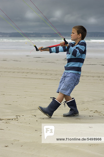Boy flying a towing kite on the Atlantic beach  Finistere  Bretagne  Britanny  France  Europe  PublicGround