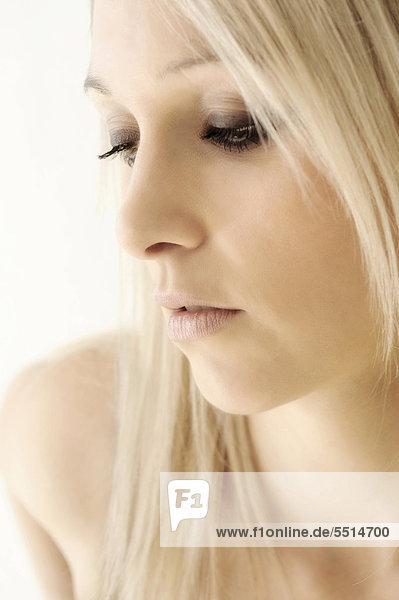 Blonde young woman  looking down  beauty portrait